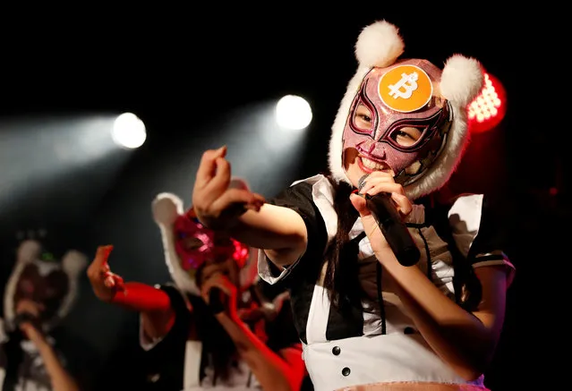 Members of Japan's idol group “Virtual Currency Girls” wearing cryptocurrency-themed masks perform in their debut stage event in Tokyo, Japan, January 12, 2018. (Photo by Kim Kyung-Hoon/Reuters)