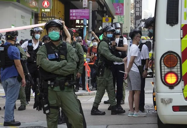 A man is arrested by police officers at a downtown street in Hong Kong Sunday, September 6, 2020. About 30 people were arrested Sunday at protests against the government's decision to postpone elections for Hong Kong's legislature, police and a news report said. (Photo by Vincent Yu/AP Photo)