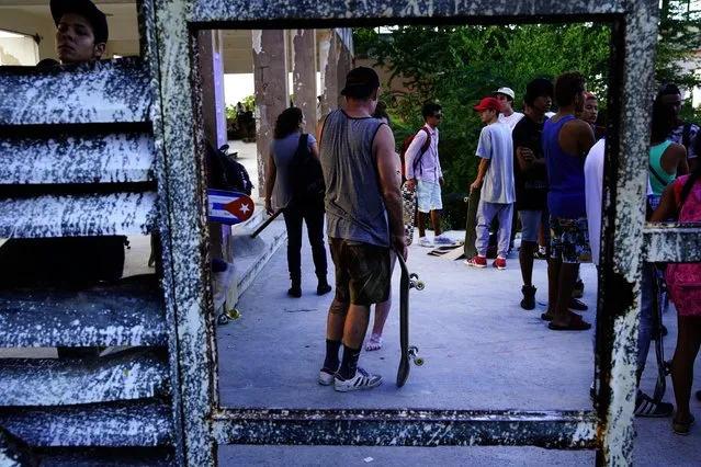 In this January 11, 2018 photo, skaters gather for the inauguration of a new recreational space for skateboarders, created in an abandoned gym at the Educational complex Ciudad Libertad, a former military barracks that the late Fidel Castro turned into a school complex after the revolution in Havana, Cuba. Cuba's government allowed the creation of another, now-deteriorating skate facility at the Metropolitan Park more than a decade ago. (Photo by Ramon Espinosa/AP Photo)
