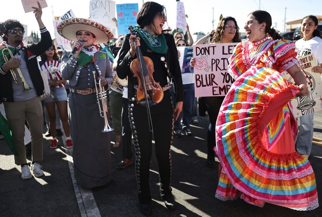 Mariachi musician Maricela Martinez (C) speaks as Audrey Alvarez (2R) dances during the “Reclaim Our Streets” event in the Boyle Heights neighborhood on July 01, 2025 in Los Angeles, California. Hundreds of demonstrators gathered and marched from Mariachi Plaza in the strongly Latino community to denounce ongoing ICE immigration raids across Los Angeles. (Photo by Mario Tama/Getty Images)