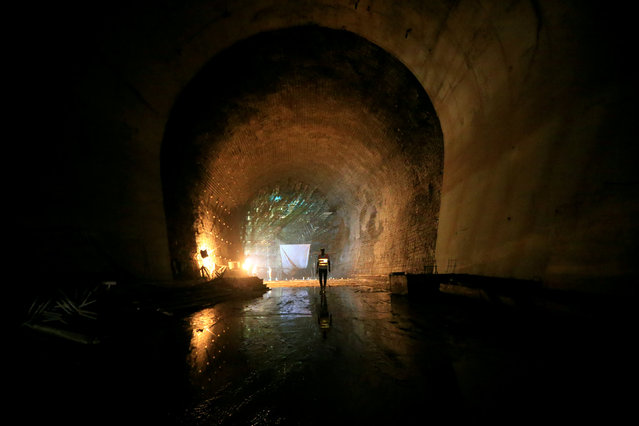 A contractor walks in a tunnel at the construction site at Karuma 600 megawatts hydroelectric power project under construction on River Nile, Uganda February 20, 2018. (Photo by James Akena/Reuters)