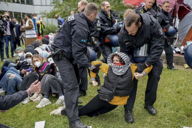 A woman is carried away by police officers during a pro-Palestinians demonstration by the group “Student Coalition Berlin” in the theater courtyard of the 'Freie Universität Berlin' university in Berlin, Germany, Tuesday, May 7, 2024. (Photo by Markus Schreiber/AP Photo)