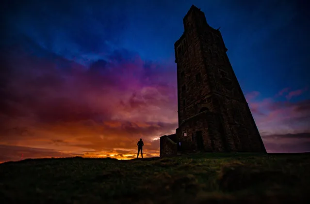 A colourful morning sunrise on Christmas Eve at Victoria Tower on Castle Hill, West Yorkshire, England on December 24, 2017. The history of human activity on the Castle Hill goes back over 4000 years. The site was developed as an iron age hill fort, surrounded by defensive ditches and ramparts. In the Middle Ages there was a castle on the hill, of which the well remains. The present tower was built to commemorate Queen Victoria's Diamond Jubilee of 1897. (Photo by Charlotte Graham/ZUMA Wire/Rex Features/Shutterstock)