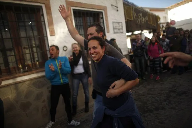 Winners of Spain's Christmas Lottery “El Gordo” celebrate in El Gastor, near Cadiz, December 22, 2014. (Photo by Jon Nazca/Reuters)