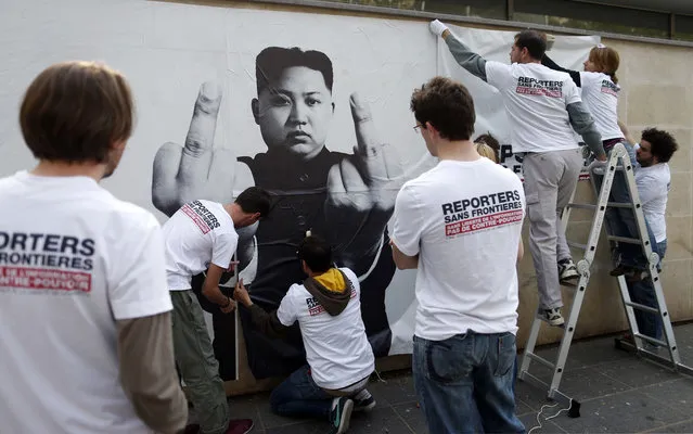 Reporters Without Borders exposes montages of world leaders, including Mahmoud Ahmadinejad (Iran), Xi Jinping (China) and Bashar al-Assad (Syria) and Vladimir Putin (Russia) in Paris, marking the 20th World Day of Freedom Media. (Photo by Vincent Bousserez/Reporters Without Borders)