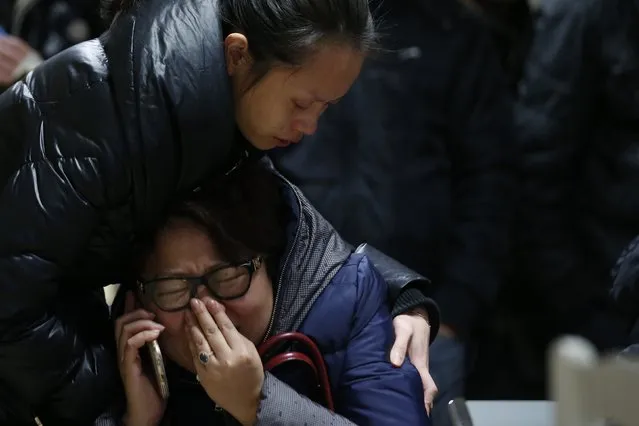 Relatives of a victim hug as they wait at a hospital where people, injured following a stampede incident, are treated in Shanghai January 1, 2015. (Photo by Aly Song/Reuters)