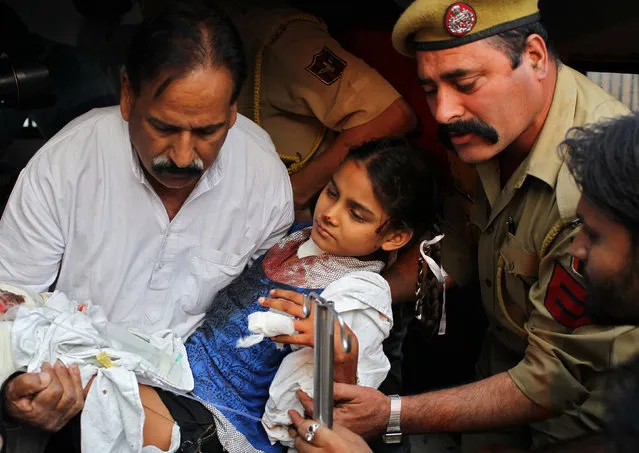 A girl, who according to local media was wounded in a shelling attack at the international border with Pakistan, is rushed to a government hospital in Ranbir Singh Pura area near Jammu, October 25, 2016. (Photo by Mukesh Gupta/Reuters)