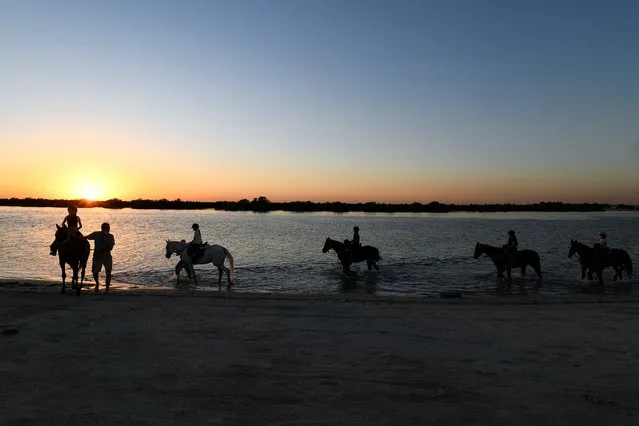 Yasmin Sayyed, founder of the Ride to Rescue program, holds a horse-riding class at a beach as a treat for a young student's birthday, in Abu Dhabi, United Arab Emirates on October 21, 2020. (Photo by Khushnum Bhanda/Reuters)