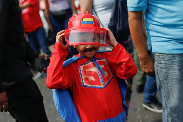 A child dressed in a “SuperBigote” (Super Mustache) superhero costume inspired by Venezuelan President Nicolas Maduro participates in the celebration of the 21st anniversary of late President Hugo Chavez's return to power after a failed coup attempt in 2002, in Caracas, Venezuela on April 13, 2023. (Photo by Leonardo Fernandez Viloria/Reuters)