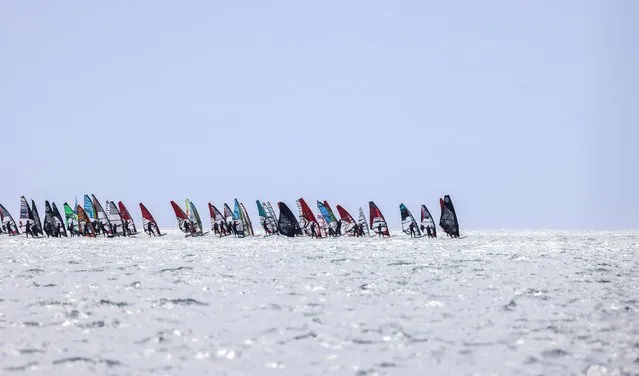 Some 1200 windsurfers take the start of the 21th edition of the Defi Wind in the Mediterranean Sea, off the coast of Gruissan in southern France, on May 19, 2023. (Photo by Charly Triballeau/AFP Photo)