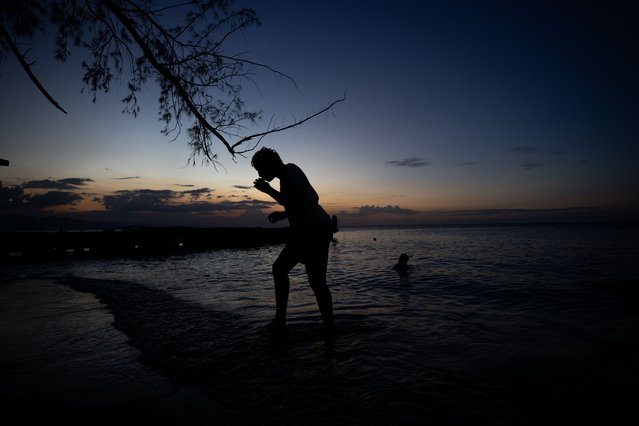 A man smokes at a beach in Montego Bay, Jamaica, 09 November 2025. (Photo by Orlando Barria/EPA)