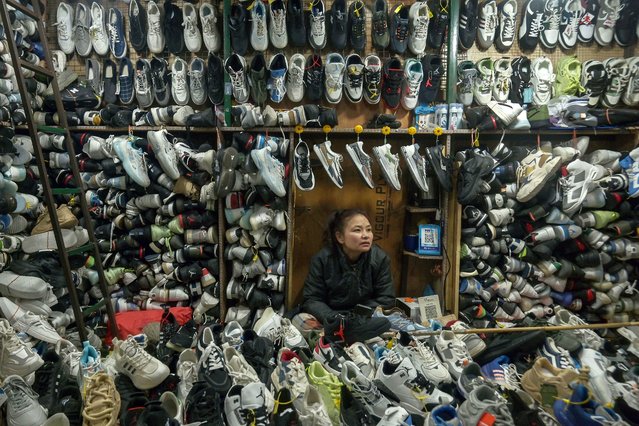 A shopkeeper selling shoes waits for customers at a market in Srinagar, India on February 7, 2025. (Photo by Tauseef Mustafa/AFP Photo)