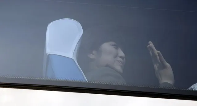 A member of the Moranbong Band from North Korea waves inside a bus as she leaves a hotel in central Beijing, China, December 11, 2015. (Photo by Reuters/Stringer)
