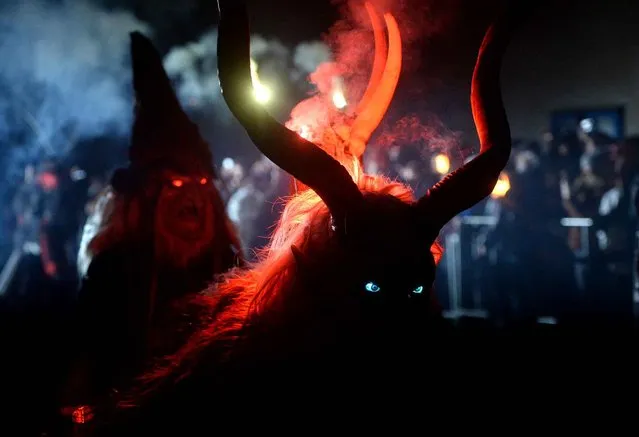 Actors dressed as “Krampus” figures present a show of a traditional custom in Kaplice, South Bohemia, on December 12, 2015. The “Krampus” figures, who belong to a centuries old custom common in the Christmas season, traditionally are known as creatures who punish children that misbehaved. (Photo by Michal Cizek/AFP Photo)