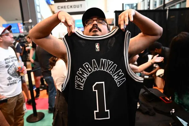 A fan displays a French basketball player Victor Wembanyama jersey after his selection as San Antonio Spurs's No. 1 pick during an NBA Draft Watch Party at the AT&T Center in San Antonio, Texas on June 22, 2023. France's Victor Wembanyama was chosen with the top pick in the NBA Draft by the San Antonio Spurs on June 22, 2023, sparking wild celebrations as the Texas club reveled in landing the gifted teenager seen as a once-in-a-generation talent. (Photo by Patrick T. Fallon/AFP Photo)