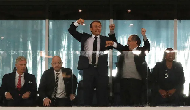 French President Emmanuel Macron (C) celebrates, alongside French Football Federation (FFF) president Noel Le Graet and French Sports Minister Laura Flessel, at the end of the Russia 2018 World Cup semi- final football match between France and Belgium at the Saint Petersburg Stadium in Saint Petersburg on July 10, 2018. France reached the World Cup final on Tuesday after a second- half header from Samuel Umtiti gave them a 1-0 win against Belgium. (Photo by Toru Hanai/Reuters)