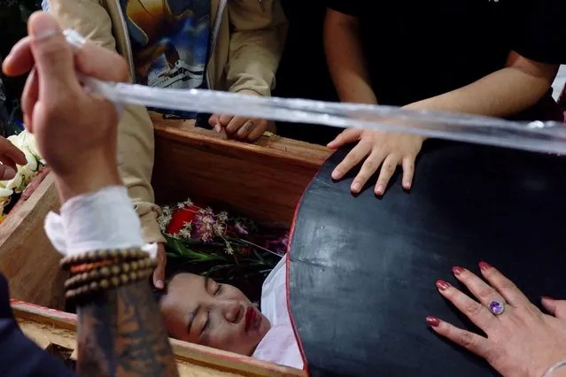 The body of 19-year-old protester Angel, also known as Kyal Sin, during her funeral in Mandalay, Myanmar, March 4, 2021 a day after she was shot in the head while taking part in a demonstration against the military coup. (Photo by Reuters/Stringer)
