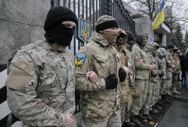Volunteers of the “Aidar” battalion picket in front of the Ministry of Defense as they protest against a decision to change the leadership of the batallion in Kiev, Ukraine, Friday, January 30, 2015. The “Aidar” battalion, a volunteer force, is in the process of being incorporated into the Ukrainian army. (Photo by Efrem Lukatsky/AP Photo)