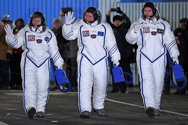 Members of the main crew of the 50/51 expedition to the International Space Station (ISS), France's astronaut Thomas Pesquet (R), Russia's cosmonaut Oleg Novitsky (C) and US astronaut Peggy Whitson wave to the crowd at the Russian-leased Baikonur cosmodrome in Baikonur, prior to blasting off to the International Space Station (ISS) late on November 17, 2016. The International crew of France's astronaut Thomas Pesquet, Russia's cosmonaut Oleg Novitsky and US astronaut Peggy Whitson are scheduled to blast off to the International Space Station (ISS) from the Baikonur cosmodrome early on November 18 local time. (Photo by Kirill Kudryavtsev/AFP Photo)