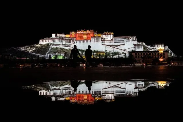 Potala Palace is lit up at night as people visit Potala Palace Square on June 16, 2023 in Lhasa, Tibet Autonomous Region, China. Chinas government says it has invested heavily in infrastructure, education, employment, health care and a regional tourism industry to develop Tibets economy. However, critics believe the scale of development is coming at an irreversible cost to culture and the environment on the Tibetan plateau by eroding traditional Tibetan religion, language, and culture. Chinese officials argue their development policies have helped to alleviate poverty and boost prosperity without diminishing religious and cultural freedoms or environmental protection. Foreign journalists are normally not permitted to travel to the autonomous region without a special permit and some were recently taken on a visit organized by local and state level officials to coincide with the 5th China Xizang Tourism and Culture Expo, the first since 2019 after the country ended its zero COVID policy late last year. (Photo by Kevin Frayer/Getty Images)