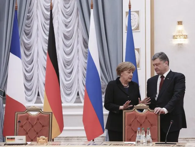 Ukraine's President Petro Poroshenko (R) talks to Germany's Chancellor Angela Merkel as they take part in peace talks on resolving the Ukrainian crisis in Minsk, February 11, 2015. (Photo by Mykhailo Palinchak/Reuters)