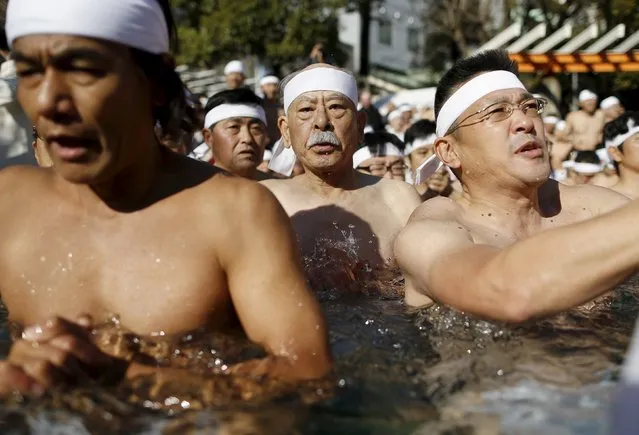 Men wearing the traditional "fundoshi" or loincloth pray as they bathe in ice-cold water at the Teppozu Inari shrine in Tokyo, Japan, January 10, 2016. (Photo by Yuya Shino/Reuters)