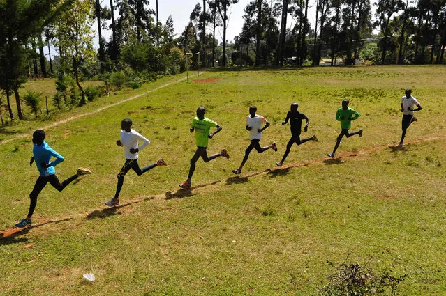 Kenyan athletes run during their training session in Iten in the Rift Valley, 329 kms north of Nairobi, on January 13, 2016. The scandal gripping athletics promises to worsen with the publication of a second explosive report on January 14 targeting corrupt "scumbags" and a leaked blood database that could have worldwide ramifications for track and field. The second report by the World Anti-Doping Agency (WADA) independent commission is understood to include shocking revelations of endemic corruption within IAAF and leading athletics federations other than Russia, such as track powerhouses Kenya. (Photo by Simon Maina/AFP Photo)