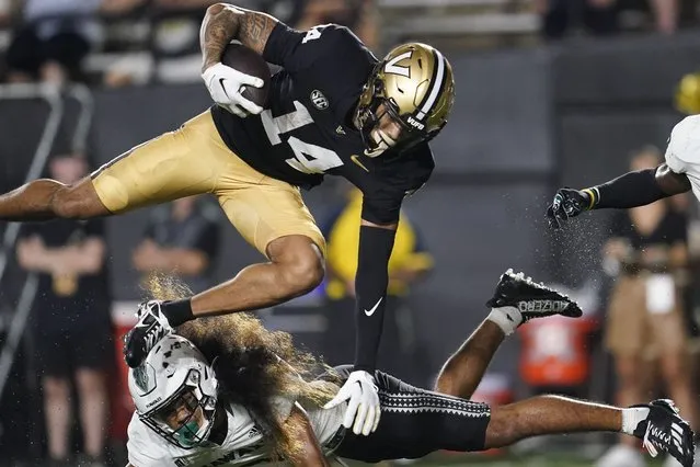 Vanderbilt wide receiver Will Sheppard (14) is stopped by Hawaii defensive back Peter Manuma during the second half of an NCAA college football game Saturday, August 26, 2023, in Nashville, Tenn. Vanderbilt won 35-28. (Photo by George Walker IV/AP Photo)