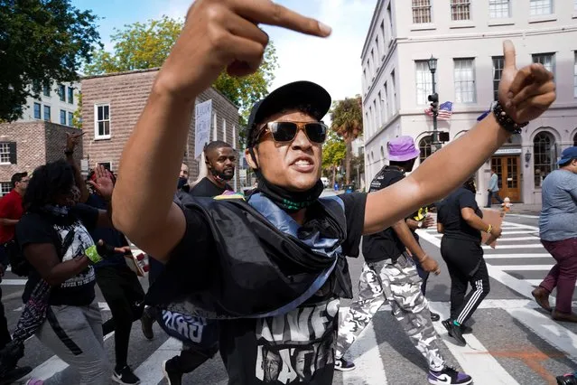 Elijah Whiteside makes an obscene gesture at law enforcement as protestors call for justice for Jamal Sutherland on May 17, 2021 in Charleston, South Carolina. Sutherland, a black man suffering from mental illness, died after Charleston County deputies shocked him with a stun gun when removing him from a jail cell. Activists want charges brought against the deputies. (Photo by Sean Rayford/Getty Images)
