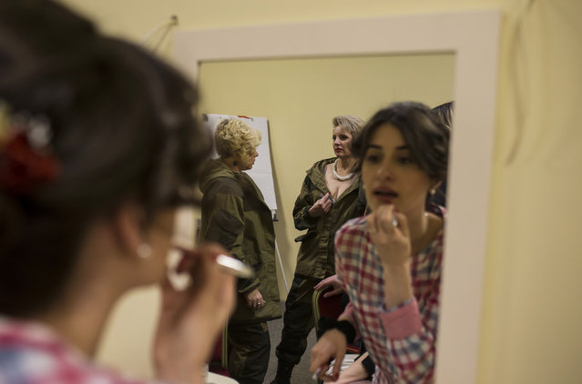 Female soldiers of the self-proclaimed Donetsk People's Republic prepare backstage during a beauty parade to mark International Women's Day in Donetsk, March 7, 2015. (Photo by Marko Djurica/Reuters)