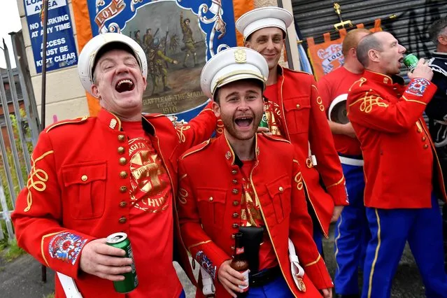 People celebrate before the Twelfth of July Orange Order march, which marks the anniversary of Protestant King William's victory over the Catholic King James at the Battle of the Boyne in 1690, through the city centre of Belfast, Northern Ireland on July 12, 2022. (Photo by Clodagh Kilcoyne/Reuters)