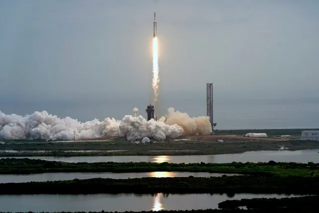 A SpaceX Falcon Heavy rocket lifts off from pad 39A at the Kennedy Space Center in Cape Canaveral, Fla., Friday, October 13, 2023. The spacecraft will travel to the metallic asteroid Psyche, where it will enter orbit in 2029 and be the first spacecraft to explore a metal-rich asteroid. (Photo by John Raoux/AP Photo)