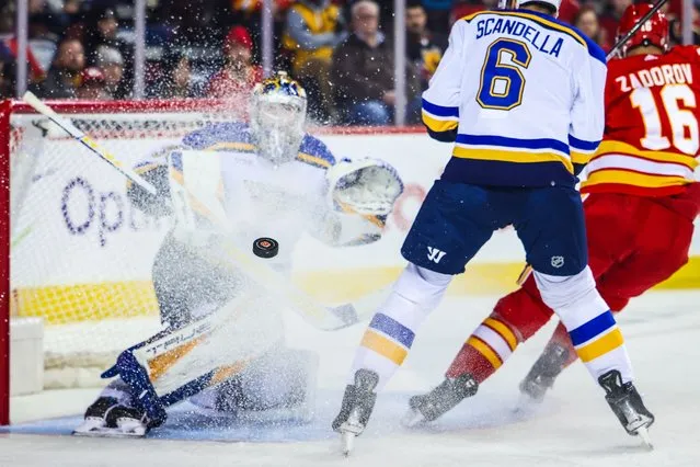 Louis Blues goaltender Joel Hofer (30) makes a save against the Calgary Flames during the second period at Scotiabank Saddledome in Calgary, Alberta on October 26, 2023. (Photo by Sergei Belski/USA TODAY Sports)