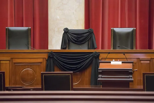 Supreme Court Justice Antonin Scalia’s courtroom chair is draped in black to mark his death as part of a tradition that dates to the 19th century, Tuesday, February 16, 2016, at the Supreme Court in Washington. Scalia died Saturday at age 79. He joined the court in 1986 and was its longest-serving justice. (Photo by J. Scott Applewhite/AP Photo)