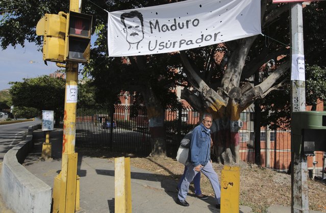 A protest sign that reads in Spanish "Maduro usurper" hangs on the day Venezuelan President Nicolas Maduro is sworn in for a second term in Caracas, Venezuela, Thursday, January 10, 2019. Maduro's second, six-year term starts amid international calls for him to step down and a devastating economic crisis. (Photo by Fernando Llano/AP Photo)