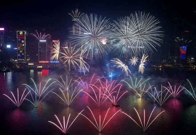 Fireworks explode over Victoria Harbour and the Hong Kong Convention and Exhibition Centre. (Photo by Tyrone Siu/Reuters)