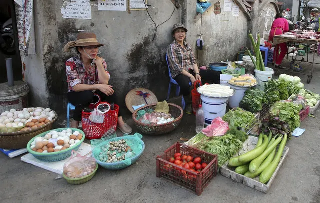 A woman sells vegetables at an outdoor market in Hanoi, Vietnam, Thursday, February 21, 2019. Vietnam, the location of President Donald Trump's next meeting with North Korean leader Kim Jong Un, has come along way since the Us abandoned its war against communist North Vietnam in the 1970s. (Photo by Minh Hoang/AP Photo)