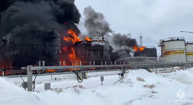 In this photo taken from video released by Governor of Bryansk Region Alexander Bogomaz telegram channel AV BogomaZ on Friday, January 19, 2024, Russian Emergency Ministry employees work at the side of fire of oil reservoirs after the drone reached Klintsy, a city in Bryansk Region of Russia, about 60 kilometers (40 miles) from the Russia-Ukrainian border. A Russian official says a Ukrainian drone has struck an oil storage depot in western Russia, causing a massive blaze. (Photo by Governor of Bryansk Region Alexander Bogomaz telegram channel AV BogomaZ via AP Photo)