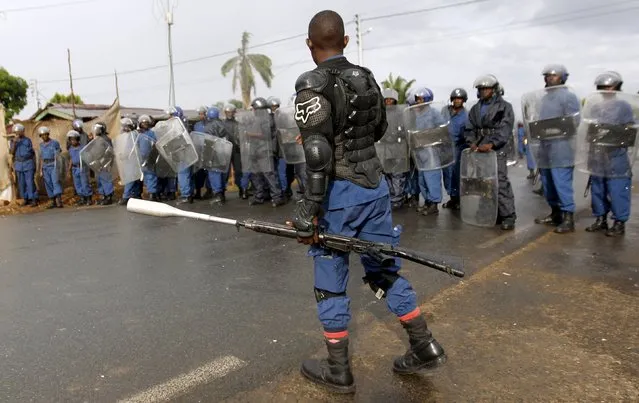 Riot policemen stand in formation during street protests against the decision made by Burundi's ruling National Council for the Defence of Democracy-Forces for the Defence of Democracy (CNDD-FDD) party to allow President Pierre Nkurunziza to run for a third five-year term in office, in the capital Bujumbura, April 26, 2015. (Photo by Thomas Mukoya/Reuters)