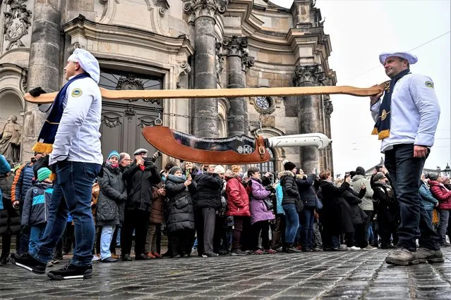 Bakers from Dresdner Stollen Association carry a giant knife during the 29th Dresden Stollen Festival in Dresden, Germany, 03 December 2022. The Stollen festival tradition dates back to 1730 and takes place on the Saturday before the second Sunday in Advent. (Photo by Filip Singer/EPA/EFE)