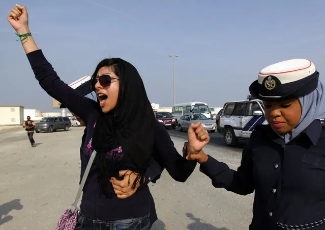 In this October 21, 2012 file photo, Bahraini opposition activist Zainab al-Khawaja, left, gestures as she shouts “God is greater than any tyrant”, while being arrested by police officers in Eker, Bahrain. On Friday, March 18, 2016, Michel Forst, the U.N. special rapporteur on the situation of human rights defenders, called on Bahrain to release al-Khawaja and her son, Abdulhadi. (Photo by Hasan Jamali/AP Photo)