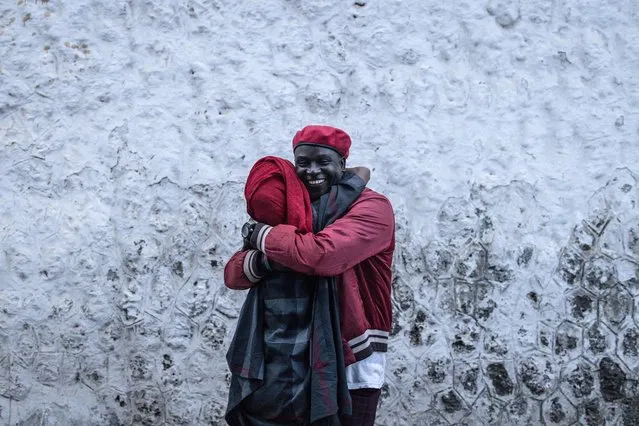 A prisoner detained in connection with the unrest over the last three years hugs a friend after being released in Dakar on February 15, 2024. (Photo by John Wessels/AFP Photo)