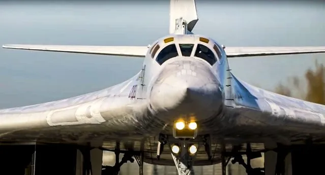 In this photo taken from video released by Russian Defense Ministry Press Service, a long-range Tu-160 bomber of the Russian Aerospace Forces takes-off to patrol in the airspace of Belarus from an air field in Russia, Thursday, November 11, 2021. Russia has sent two nuclear-capable strategic bombers on a training mission over Belarus in a show of Moscow's support for its ally amid a dispute over migration at the Polish border. Russia has supported Belarus amid a tense standoff this week as thousands of migrants gathered on the Belarus-Poland border in hopes of crossing into Europe. (Photo by Russian Defense Ministry Press Service via AP Photo)