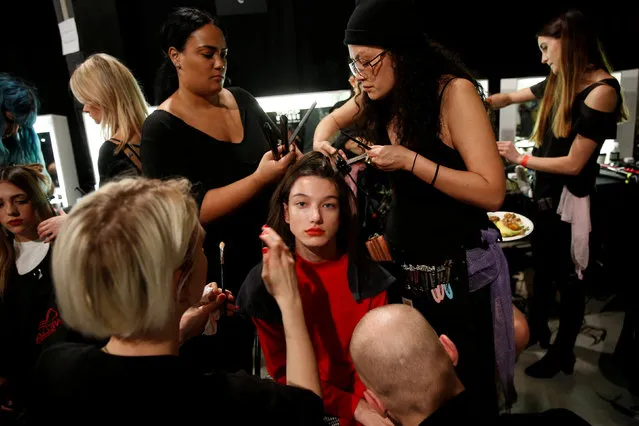 A model is groomed backstage at the Topshop Unique catwalk show during London Fashion Week in London, Britain February 19, 2017. (Photo by Neil Hall/Reuters)