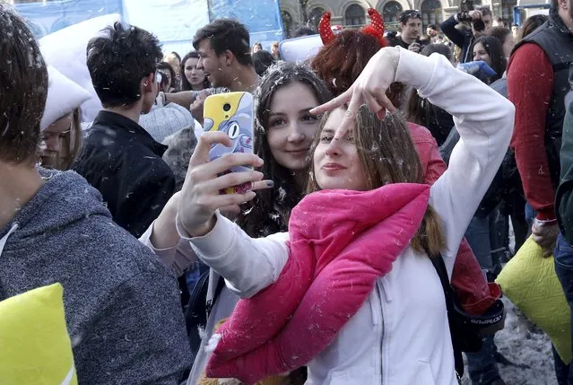 Two Romanian young women make a 'selfie' snapshot after fighting with pillows during the International Pillow Fight Day in Bucharest, Romania, 02 April 2016. (Photo by Robert Ghement/EPA)