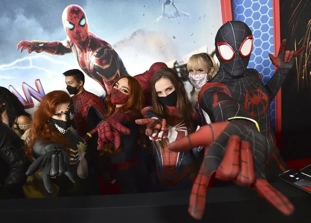 People dressed in costume pose on the red carpet at the premiere of “Spider-Man: No Way Home” on Monday, December 13, 2021, in Los Angeles. (Photo by Jordan Strauss/Invision/AP Photo)