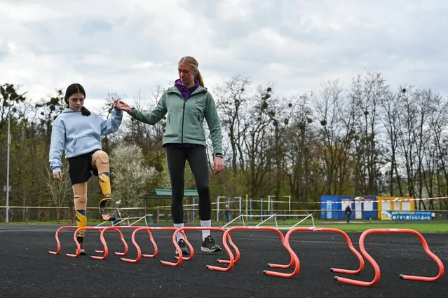 A 12-year-old Ukrainian Yana Stepanenko who lost both her legs in a Russian missile attack on the Kramatorsk train station and now prepares to run the Boston Marathon 5K 2024 race on prostheses is seen during an open training session, Lviv, western Ukraine on April 4, 2024. (Photo by Ukrinform/Rex Features/Shutterstock)