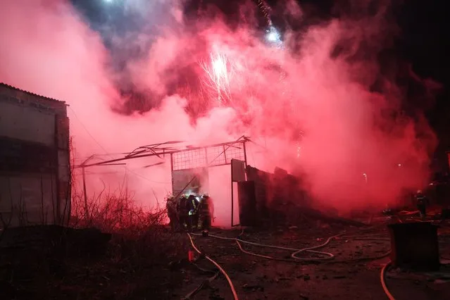 Firefighters work to put out a fire at a fireworks storage facility after it was struck by a Russian missile in a residential neighborhood late Tuesday evening on January 10, 2023 in Kharkiv, Ukraine. Kharkiv, the second largest city in Ukraine, has been repeatedly targeted by Russia since it invaded the country nearly one year ago. (Photo by Spencer Platt/Getty Images)