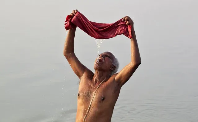 A Hindu devotee uses a cloth filter as he drinks water from the Ganges river on a hot summer morning in Allahabad, India, April 18, 2016. The temperature in Allahabad on Monday is expected to reach 43 degrees Celsius (109.4 degrees Fahrenheit), according to India's metrological department website. (Photo by Jitendra Prakash/Reuters)