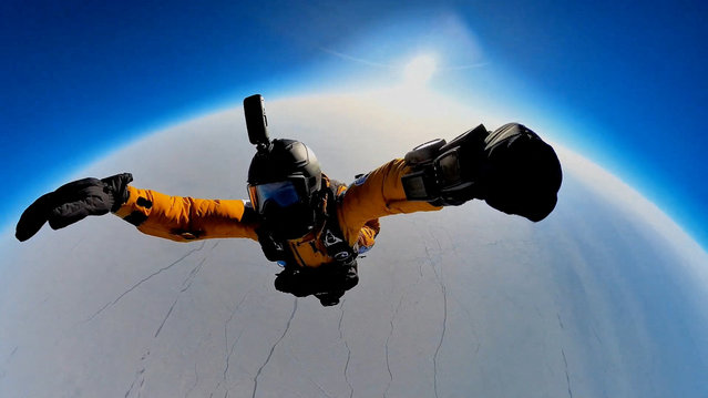 Denis Yefremov, space technology engineer, performs a parachute jump from the Earth's stratosphere to the area near the Russian polar station Barneo close to the North Pole, on April 12, 2024, in this still image taken from video. (Photo by Denis Efremov/RUVDS via Telegram/Handout via Reuters)